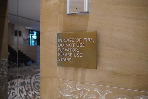 A sign that says, In Case Of Fire, Do Not Use Elevator, Please Use Stairs, wh Stock Photos