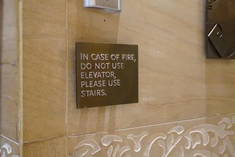 A sign that says, In Case Of Fire, Do Not Use Elevator, Please Use Stairs, wh Stock Photos