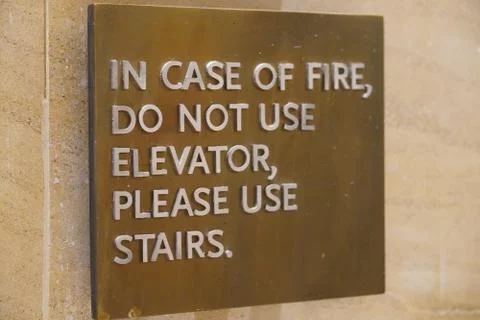 A sign that says, In Case Of Fire, Do Not Use Elevator, Please Use Stairs, wh Stock Photos