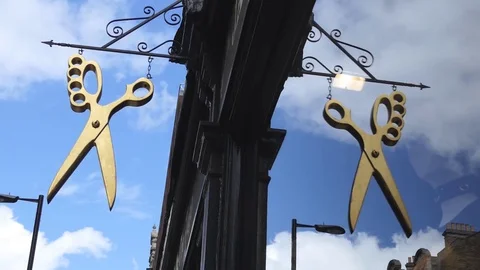 A sign of the scissors above the tailor's shop. Stock Footage