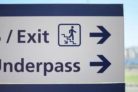 Sign showing direction to exit and underpass Stock Photos