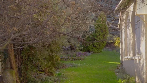 A sign on the side of a building Beautiful courtyard with a green lawn. An old Stock Footage 126841953