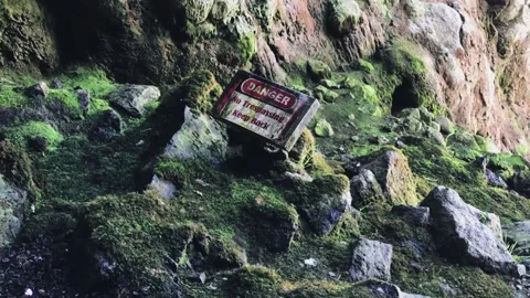 A sign on the side of a rocky mountain 動画素材 155591135