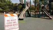 A Sign States That A Playground Is Closed Down Due To Coronavirus Restrictions. Stock Footage