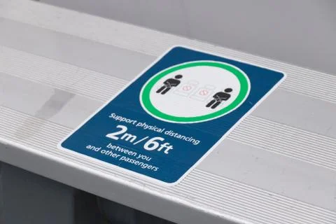 Sign "Support physical distancing 2 metres between you and other passengers" Stock Photos