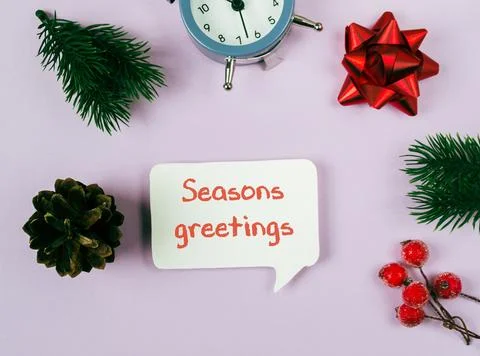 The sign is surrounded by various decorations, including a clock, a pine tree Foto stock