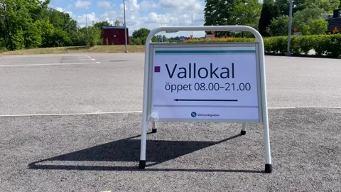 Sign in Swedish with opening hours for the polling station on election day Stock Footage 289675365