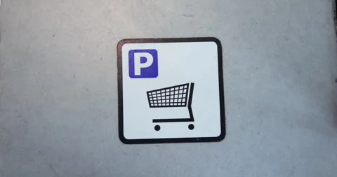 Sign on wall with dashed lines indicates parking area for shopping carts Stock Footage 310259072