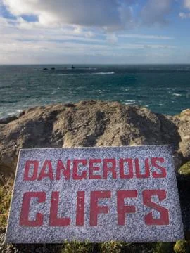 Sign warning of dangerous cliffs Stock Photos