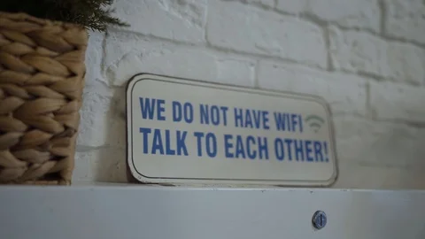 A sign "we do not have wi-fi" standing on the shelf Stock Footage 102258457
