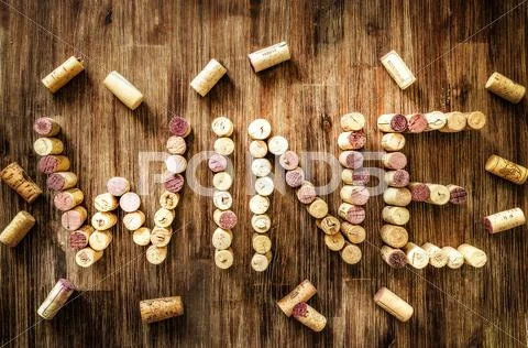 Sign wine made from corks on old wooden vintage table Stock Photos
