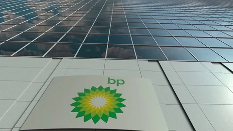 Signage board with BP logo. Modern office building facade time lapse. Editorial Stock Footage