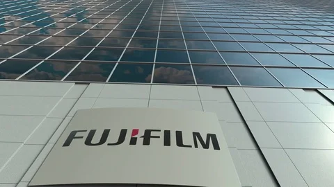 Signage board with Fujifilm logo. Modern office building facade time lapse Stock Footage
