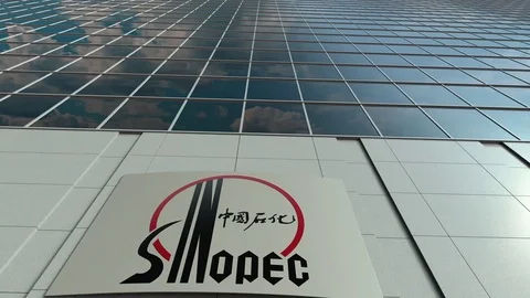 Signage board with Sinopec logo. Modern office building facade time lapse Stock Footage