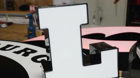 A Signage Cut-out Being Opened By A Male Worker Stock-Footage 134162932