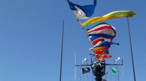 Signal flags flying against blue sky 10167 Stock Footage