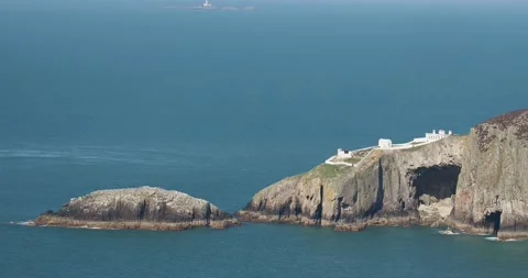 A signal station on North Stack, Anglesey, Wales, UK with the Skerries in the Stock Footage 240093373