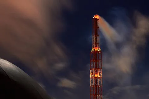 Signaled with red lights selective focus smoke pipe and spherical gasholder of Stock Photos