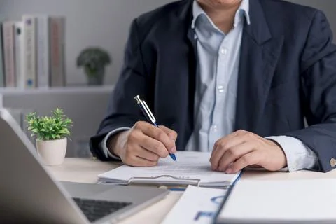 Signature, document Manager writes on contract at modern office to confirm .. 스톡 사진