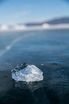 A significant chunk of ice is resting on a solid frozen surface Stock Photos