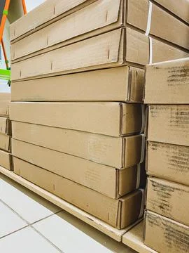 A significant stack of cardboard boxes has been meticulously stacked on top.. Stock Photos
