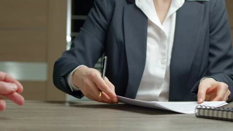 Signing a contract between two partners sitting at the table. Signing a document Stock Footage 263995217