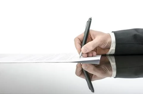 Signing a contract on a black table. With copy space and reflection. Stock Photos