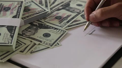Signing Contract with Cash on Desk Stock Footage 340901580