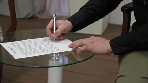 Signing a Contract: A Focused Moment of Commitment and Agreement Stock Footage 300669216
