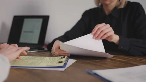 Signing the contract in the office. The manager explains the terms of the Stock Footage 237059154