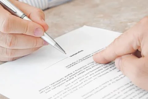 Signing a Document Stock Photos