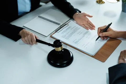 The signing of important documents between the lawyer and the client to enter Stock Photos