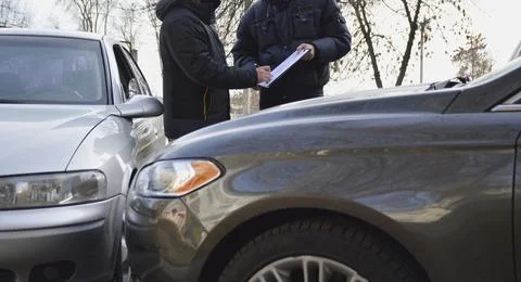 Signing the protocol at the scene of the accident of two cars Stock Photos