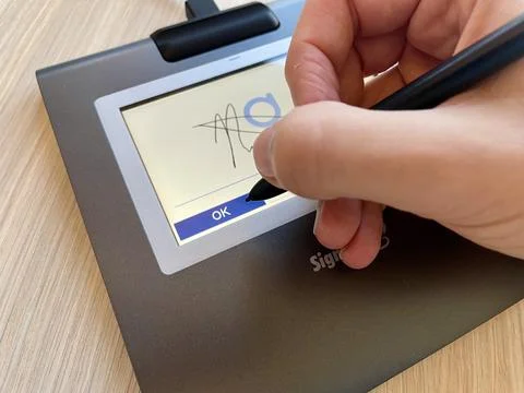 Signpad - a device designed to digitally capture biometric signatures. A man's Stock Photos