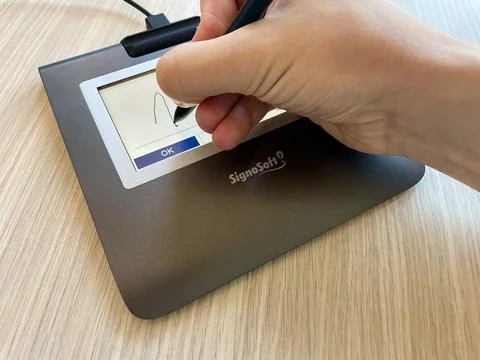 Signpad - a device designed to digitally capture biometric signatures. A man's Stock Photos