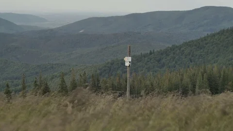 Signpost of hiking trails indicating the direction on the background of mountain Vídeos de archivo 77618149