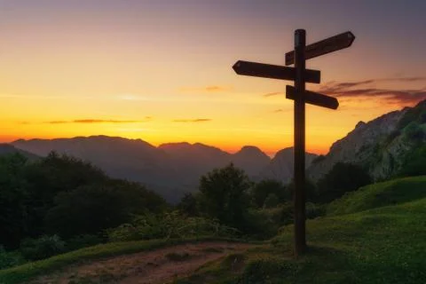 Signpost in the mountain at sunset Stock Photos