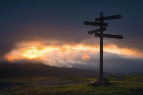 Signpost in the mountain at sunset Stock Photos