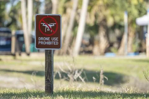 Signpost with warning about drone usage prohibition in state park. Warning Stock Photos