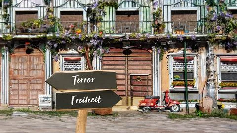 Signposts the direct way to Freedom versus Terror Stock-Fotos