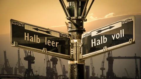 Signposts the direct way to half full versus half empty Stock Photos