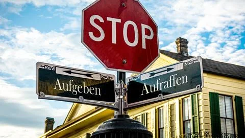 Signposts the direct way to Pick up versus Give up Stock Photos