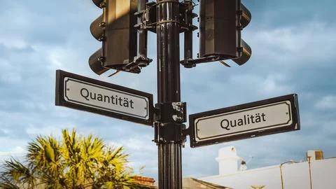 Signposts the direct way to quality versus quantity Stock Photos