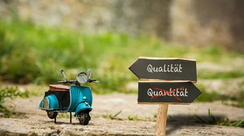 Signposts the direct way to quality versus quantity - Bildmontage An image... Stock Photos