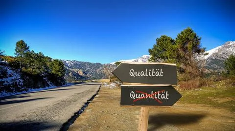 Signposts the direct way to quality versus quantity - BILDMONTAGE An image... Stock Photos