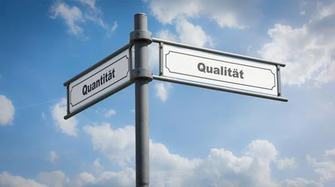 Signposts the direct way to quality versus quantity - BILDMONTAGE An image... Stock Photos