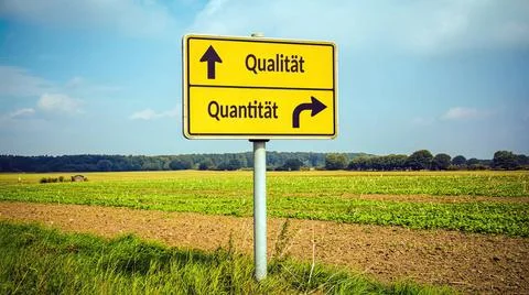 Signposts the direct way to quality versus quantity - Bildmontage An image... Stock Photos