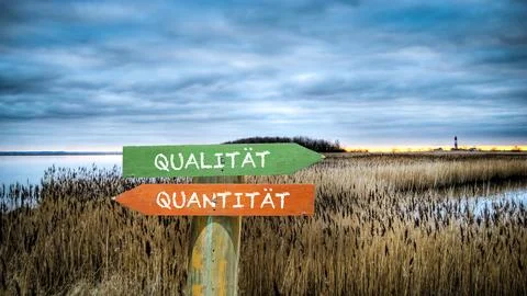Signposts the direct way to quality versus quantity Stock Photos