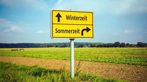 Signposts the direct way to winter versus summer Stock Photos