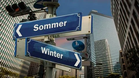 Signposts the direct way to winter versus summer Stock Photos